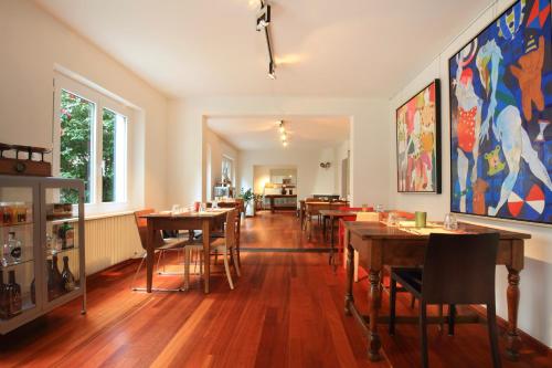 a dining room with wooden tables and chairs at B&Borgo in Ascona