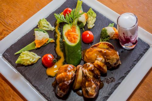 a plate of food with vegetables on a table at Hotel de Moiry Supérieur in Grimentz