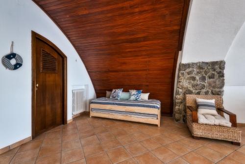a bedroom with a bed and a wooden ceiling at La Casa del Verricello - Sea view house in Meta