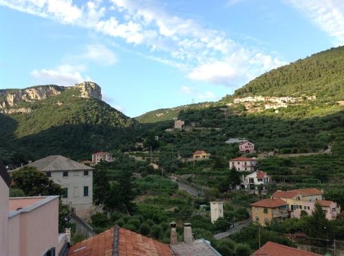 uma cidade numa colina com casas e montanhas em B&B Lacrêma em Finale Ligure