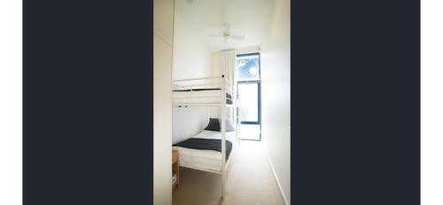 een kamer met 2 stapelbedden en een hal bij Seashells Penneshaw in Penneshaw