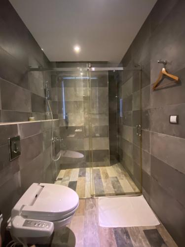 a bathroom with a toilet and a shower at 3 Door Hotel in Tainan