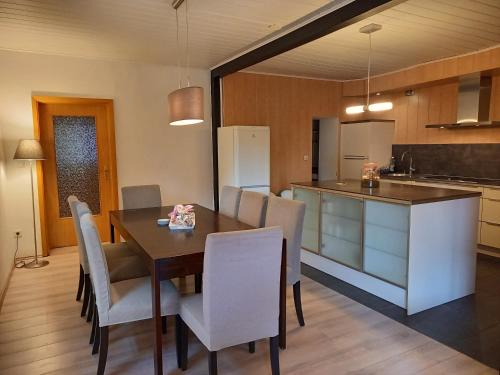a kitchen and dining room with a table and chairs at Heester Apartments in Bunde