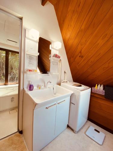 a bathroom with a sink and a washing machine at Sea Breeze in Onna