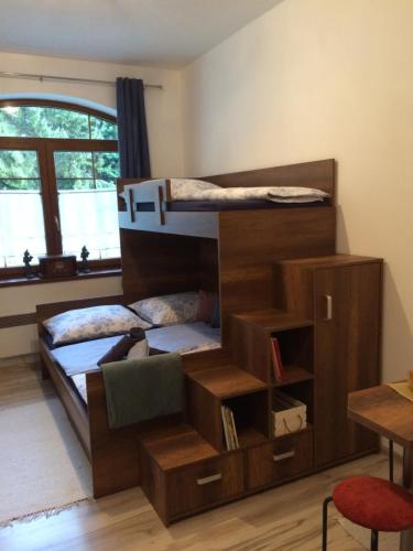 a bedroom with two bunk beds and a desk at AD Kamzík Donovaly in Donovaly