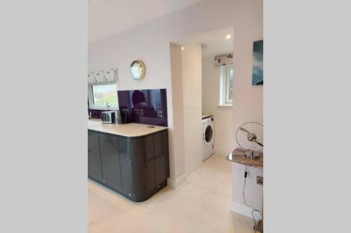 a kitchen with a sink and a counter top at The Causeway in Bracadale