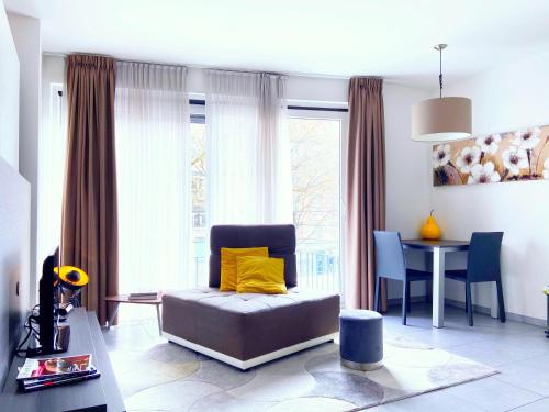 ein Wohnzimmer mit einem Stuhl und einem Tisch in der Unterkunft Quartier des Quais Dansaert in Brüssel