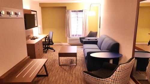 a living room with a couch and a table at Holiday Inn Express and Suites Surrey by IHG in Surrey