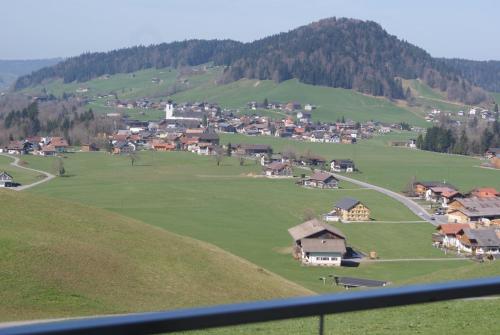 a small village on a green hill with houses at Haus Eberle in Hittisau