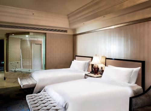 a hotel room with two beds and a window at InterContinental Lhasa Paradise by IHG in Lhasa