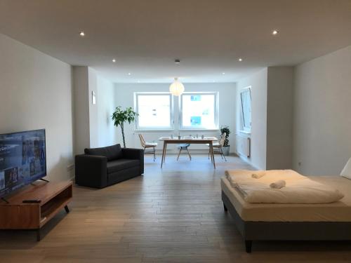 a living room with a bed and a dining room at Monteurwohnung Pforzheim Zentrum in Pforzheim