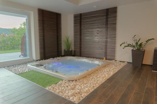 a jacuzzi tub in a room with a window at Private Family Villa in Budaörs