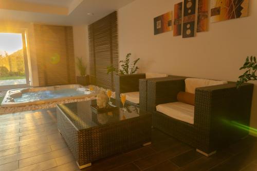 a living room with a jacuzzi tub and a table at Private Family Villa in Budaörs