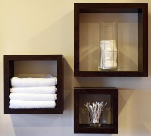 two framed towels and a glass vase on a wall at Rowan Cottage Self Catering in Portree