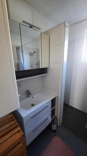 a bathroom with a white sink and a mirror at Appartement Wagner in Weiz