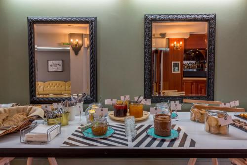 a table with food on it with a mirror at Alexios Hotel in Ioannina