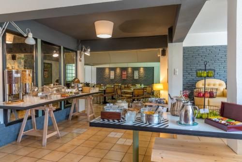 a restaurant with a counter with pots and pans at Alexios Hotel in Ioannina