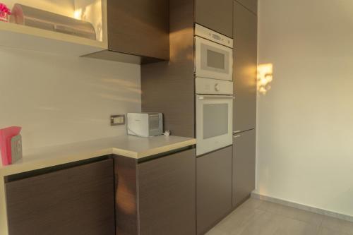 a small kitchen with a microwave and a stove at Private Family Villa in Budaörs