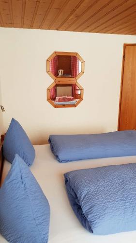 a bedroom with two beds and a shelf on the wall at Gasthof Schoenegg B&B in Goldswil