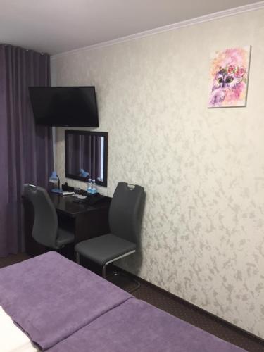 Una televisión o centro de entretenimiento en Hotel Tourist