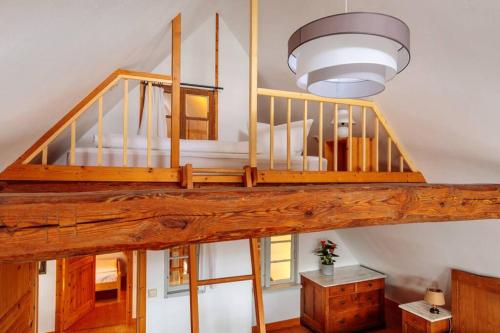 a loft bed in a house with a light at Ferienwohnung Familienzeit mit Sauna in Hohen Pritz