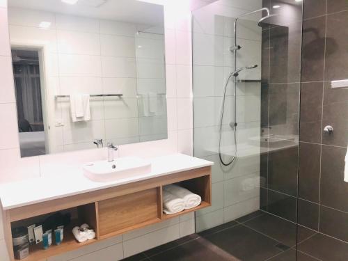 a bathroom with a sink and a shower at Hive Hotel, Moruya in Moruya