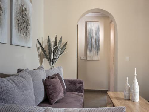 a living room with a couch and a table at Minas Sublime Villa, a Magical Sanctuary, By ThinkVilla in Kipseli