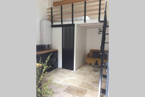 a bedroom with a bunk bed in a room at Studio Moderne in Saint-Symphorien-dʼOzon