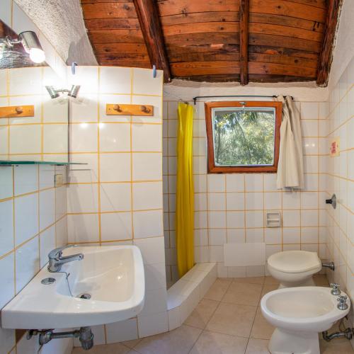 a bathroom with a sink and a toilet at Cugnana Porto Rotondo Bungalows - Camping in Cugnana