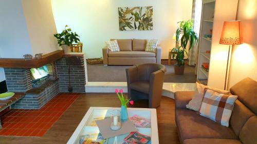 a living room with a couch and a table at Gästehaus Sonnenhügel in Möhnesee