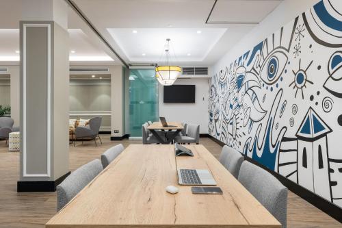 an office with a conference table and a mural at Hotel LIVVO Fataga in Las Palmas de Gran Canaria