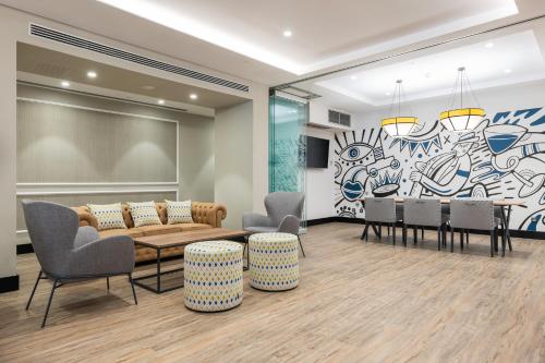a living room with a table and chairs and a mural at Hotel LIVVO Fataga in Las Palmas de Gran Canaria