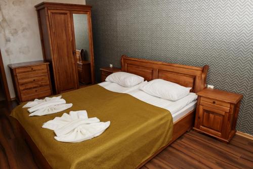 a bedroom with a bed with two towels on it at Forest Nook Aparthotel in Pamporovo