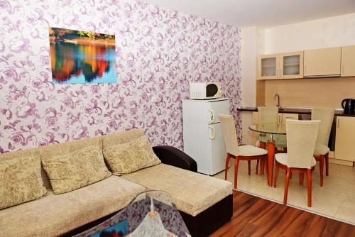 a living room with a couch and a table at Forest Nook Aparthotel in Pamporovo