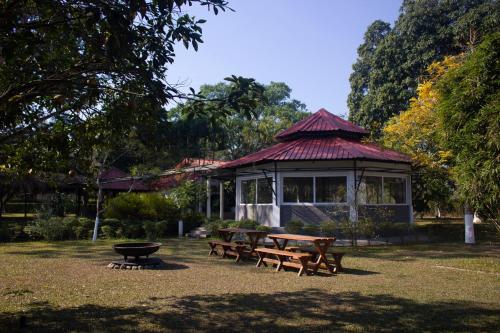 a picnic area with a gazebo in a park at Puroni Bheti Tea and Farm Retreat in Jorhāt