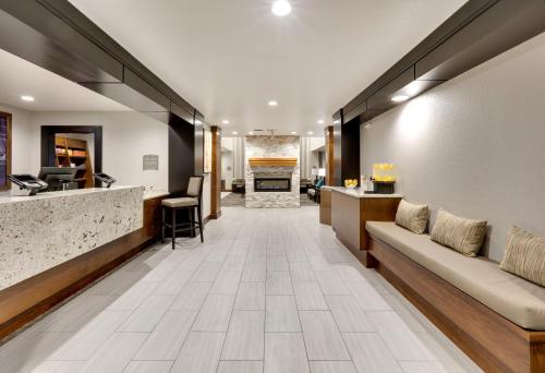 a lobby of a hotel with a couch and a bar at Staybridge Suites San Antonio - Schertz by IHG in Schertz