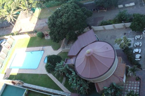 an overhead view of a swimming pool and an umbrella at Stella Maris 144 in Amanzimtoti