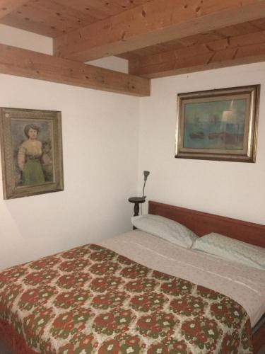 a bedroom with a bed and a painting on the wall at Casa con giardino vicino al mare in Massa