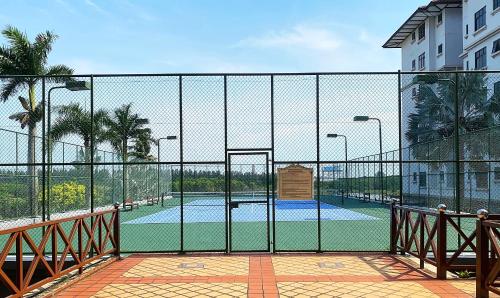 a view of a tennis court through a fence at Amadel Residence 爱媄德民宿 1314 in Melaka