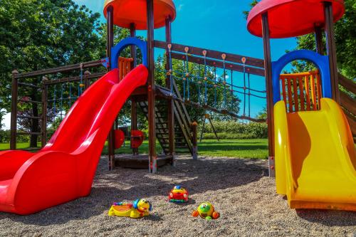 a playground with a slide and toys in the sand at Agriturismo Il Brugnolo in Scandiano