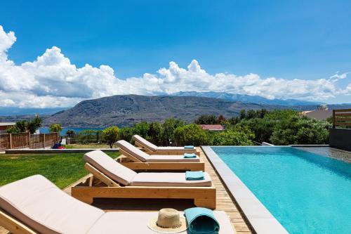a swimming pool with lounge chairs next to a swimming pool at Artemisia Residence in Chania Town