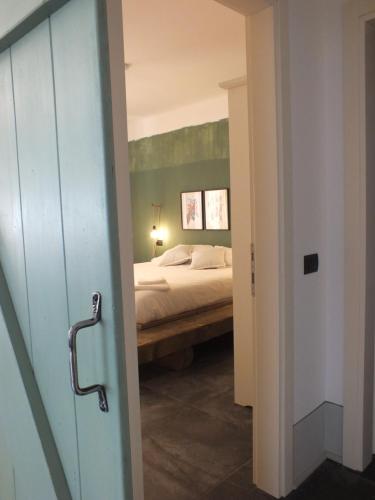 a bedroom with a bed in a room with a door at Rocca d'Anfo B&B-Apartments Lake View in Rocca dʼAnfo