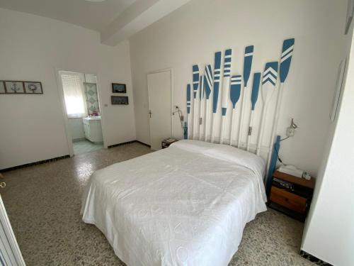 a bedroom with a bed with blue and white art on the wall at Sa Caletta Appartamenti in Portoscuso
