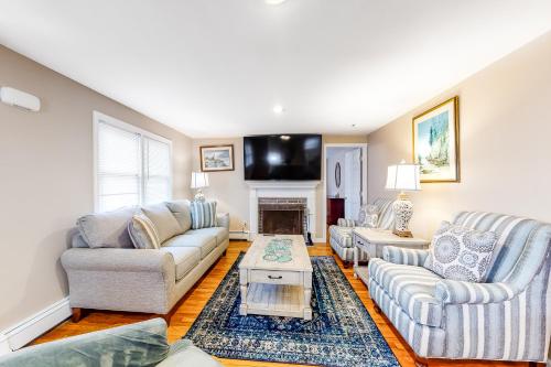 a living room with two couches and a tv at Cape Cod Playhouse in Yarmouth