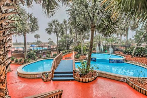 
a large pool with a bunch of palm trees in it at Beachfront Resort Condo with Lazy River and Pools! in Myrtle Beach
