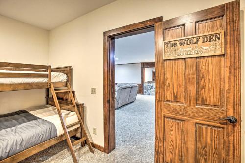 a bedroom with bunk beds and a door with the words the wolf den at Lodge on 104 Acres with Fire Pit in Boyne City in Petoskey