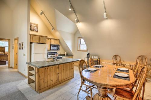 a kitchen and dining room with a wooden table at Lodge on 104 Acres with Fire Pit in Boyne City in Petoskey