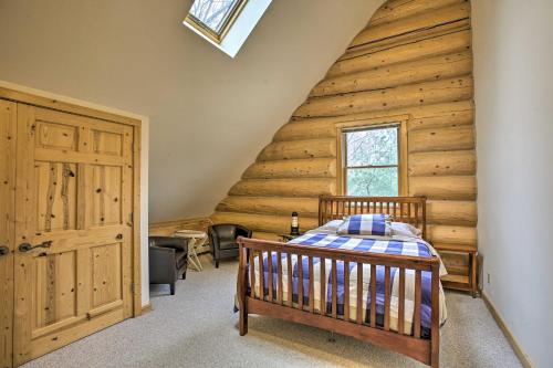 a bedroom in a log cabin with a bed at Lodge on 104 Acres with Fire Pit in Boyne City in Petoskey