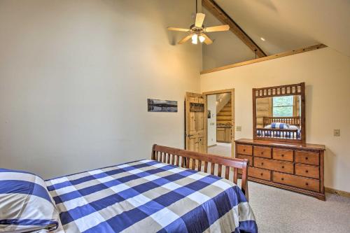 a bedroom with a bed and a dresser and a mirror at Lodge on 104 Acres with Fire Pit in Boyne City in Petoskey