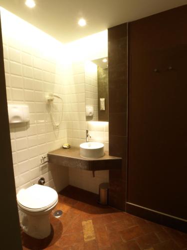 a bathroom with a white toilet and a sink at Le Stanze Del Duomo in Anagni